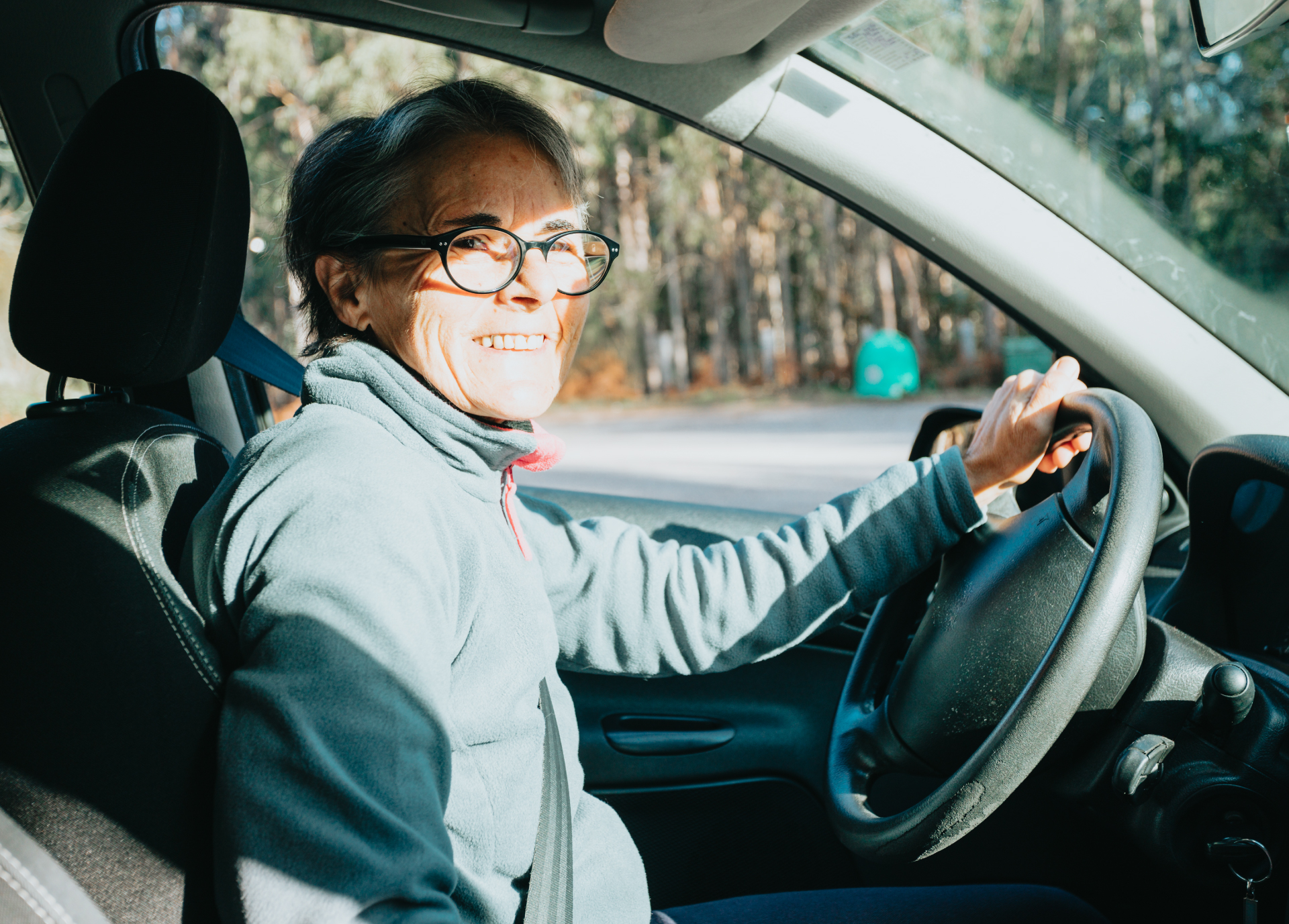 TGP_VolunteerDriver_V1 Woman driving and smiling.
