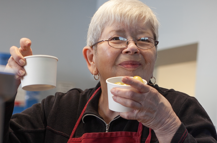 One of our lovely volunteers handing out cups of fresh fruit.